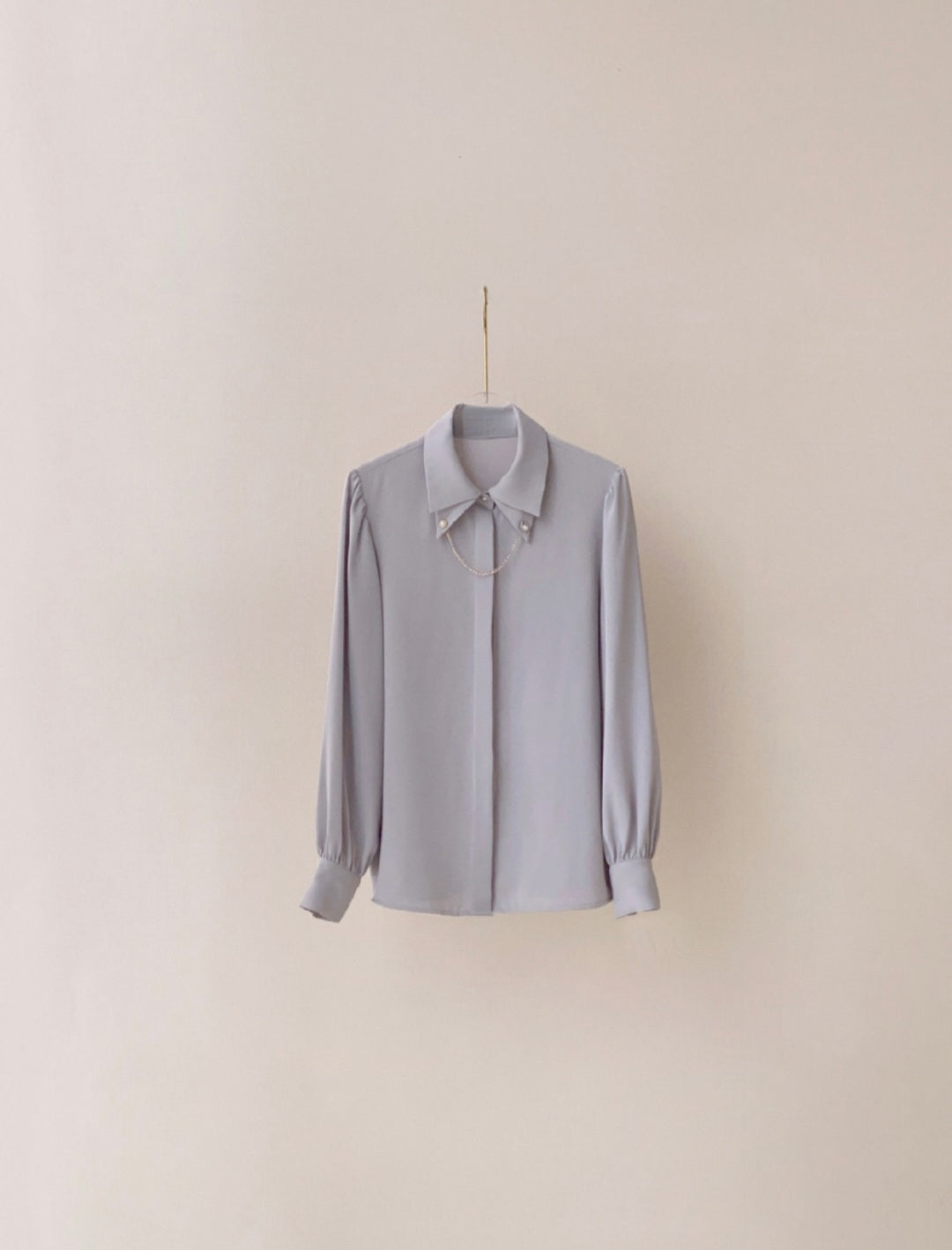 Shirt with cuff link chain