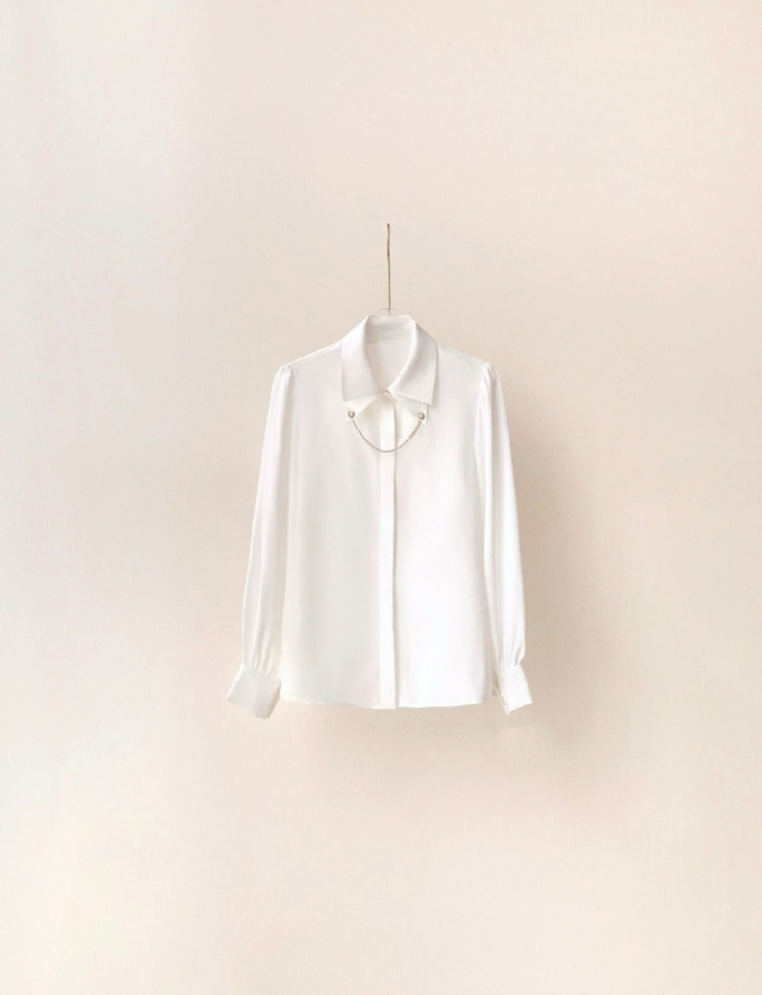 Shirt with cuff link chain