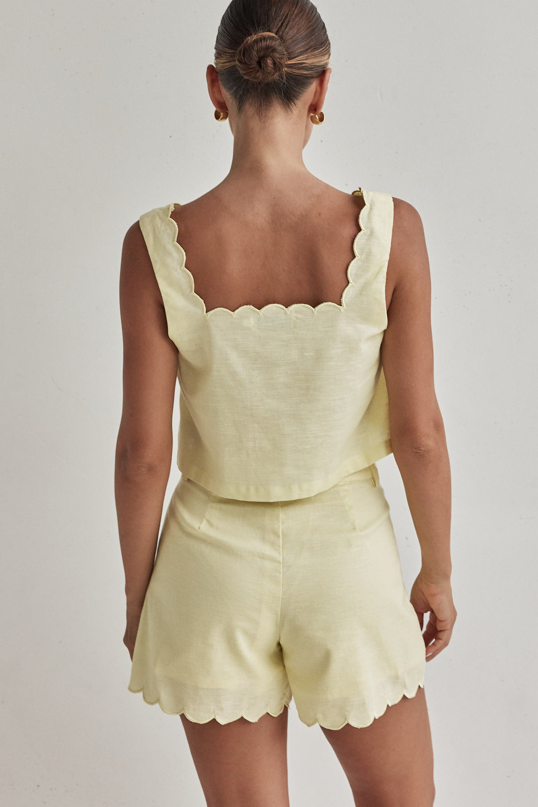 Butter yellow linen shorts for women with scalloped hem and high waist